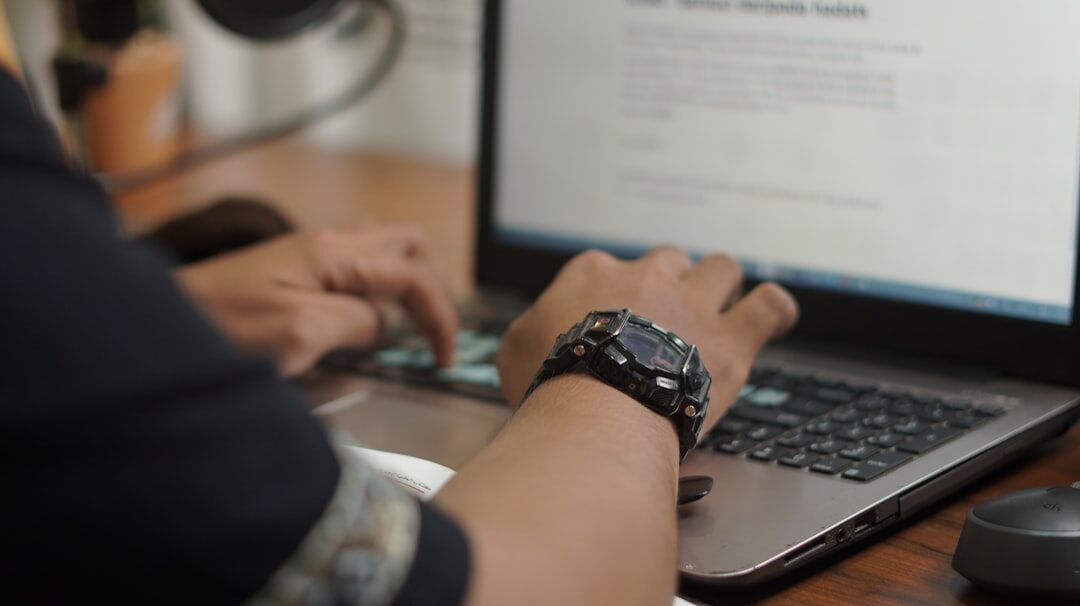person writing article on computer